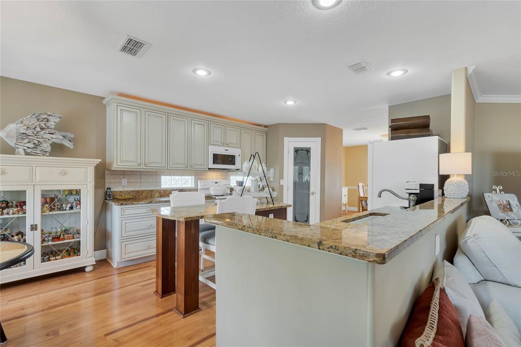 4049 Cobia Drive Hernando Beach, FL 34607 - Photo 8 of 40 a open kitchen with stainless steel appliances granite countertop a sink refrigerator and cabinets