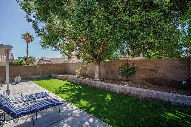 a view of a backyard with sitting area