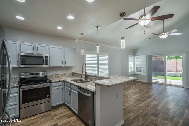 a kitchen with a stove a sink and a refrigerator