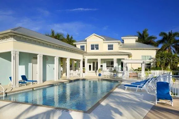 a view of a swimming pool with a patio and a garden