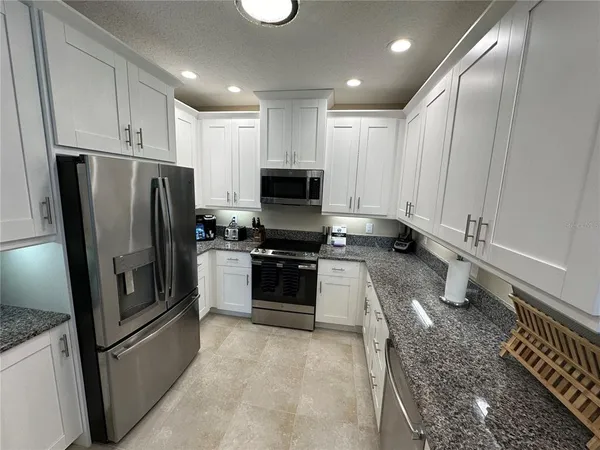a kitchen with stainless steel appliances a refrigerator and a stove