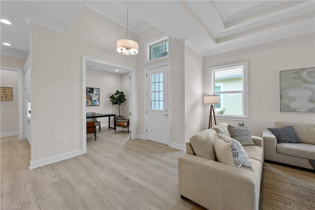 6385 Arriba Avenue Naples, FL 34113 - Photo 11 of 43 a living room with furniture and wooden floor