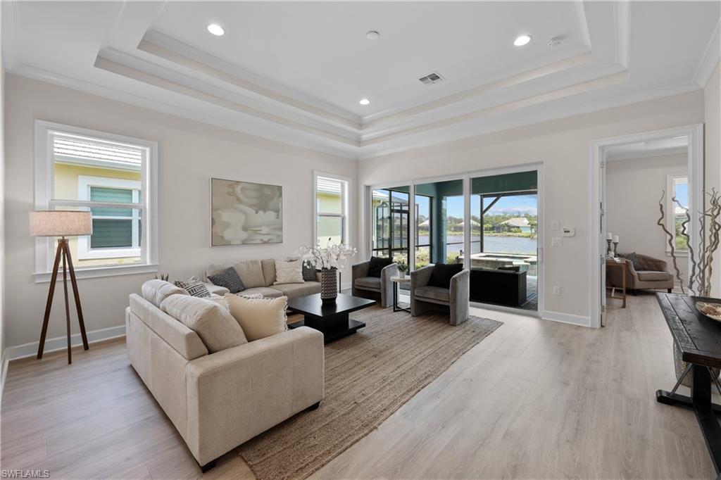 6385 Arriba Avenue Naples, FL 34113 - Photo 12 of 43 a living room with furniture and a wooden floor