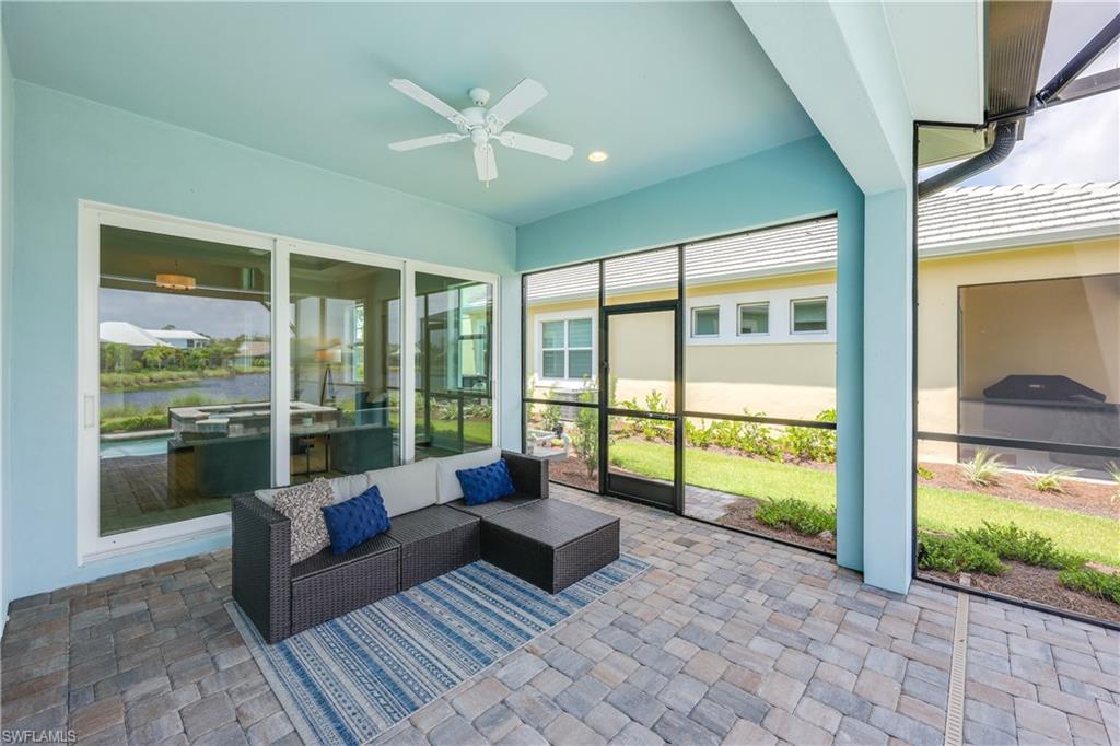 6385 Arriba Avenue Naples, FL 34113 - Photo 13 of 43 a living room with furniture and floor to ceiling windows