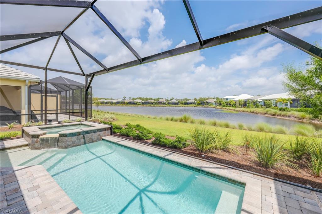 6385 Arriba Avenue Naples, FL 34113 - Photo 15 of 43 a view of a swimming pool with a lake view