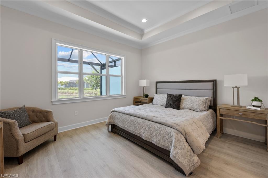 6385 Arriba Avenue Naples, FL 34113 - Photo 17 of 43 a bedroom with a bed couch and window