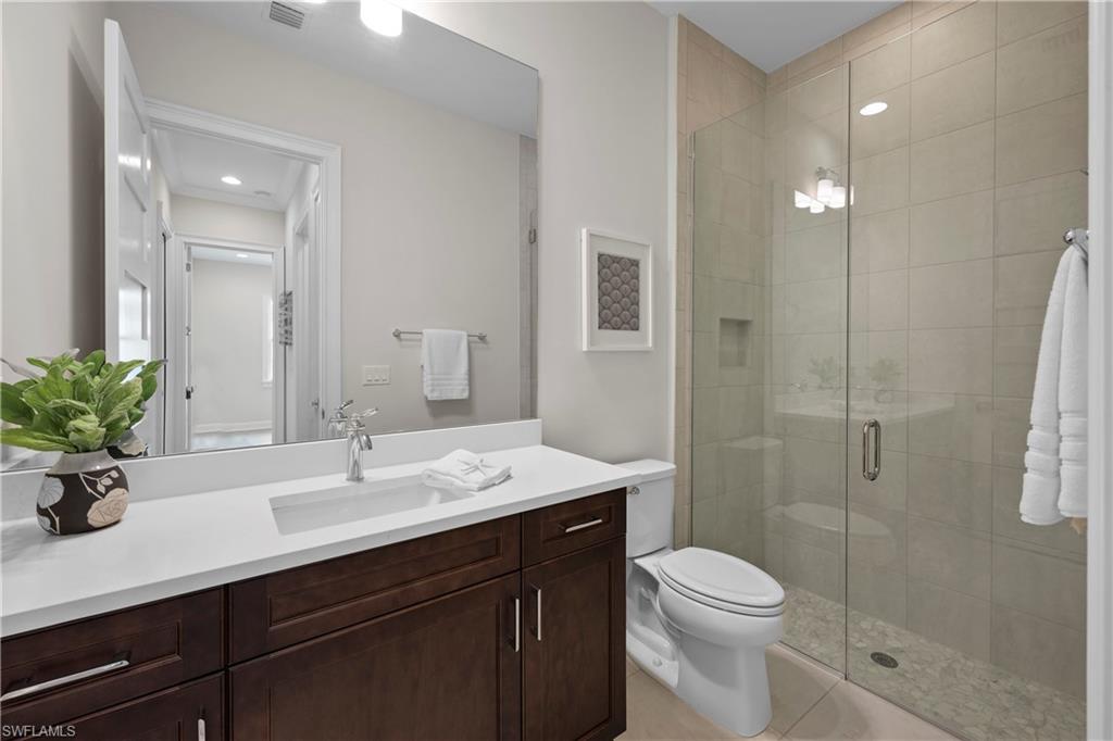 6385 Arriba Avenue Naples, FL 34113 - Photo 21 of 43 a bathroom with a sink a toilet and shower