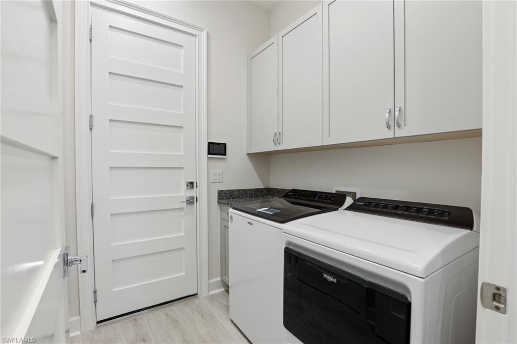 6385 Arriba Avenue Naples, FL 34113 - Photo 22 of 43 a utility room with washer and dryer