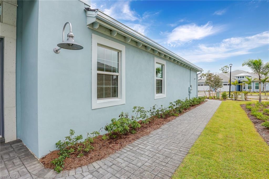 6385 Arriba Avenue Naples, FL 34113 - Photo 25 of 43 a front view of a house with a yard