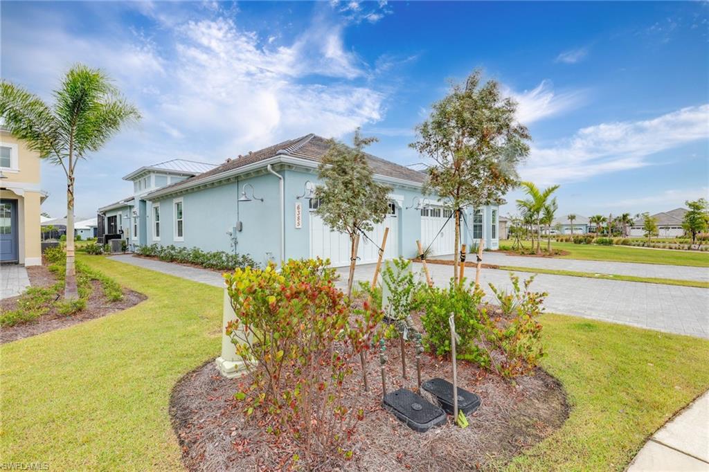 6385 Arriba Avenue Naples, FL 34113 - Photo 28 of 43 a front view of a house with garden