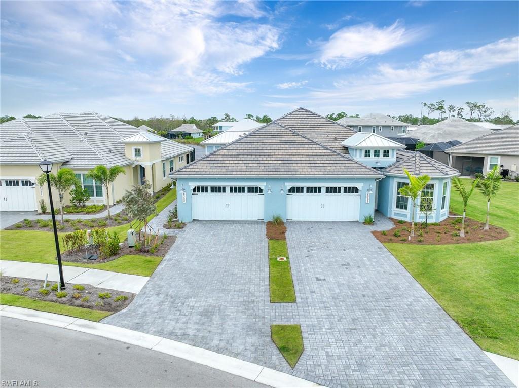 6385 Arriba Avenue Naples, FL 34113 - Photo 3 of 43 a view of a house with a yard and table