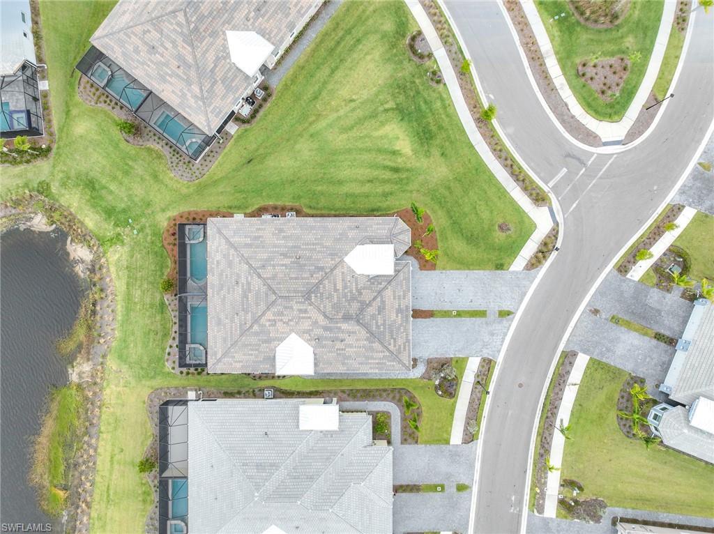 6385 Arriba Avenue Naples, FL 34113 - Photo 34 of 43 an aerial view of a residential houses with outdoor space and swimming pool