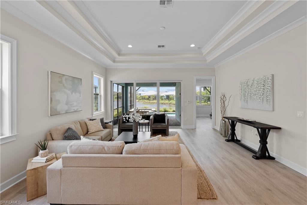 6385 Arriba Avenue Naples, FL 34113 - Photo 10 of 43 a living room with furniture and a window