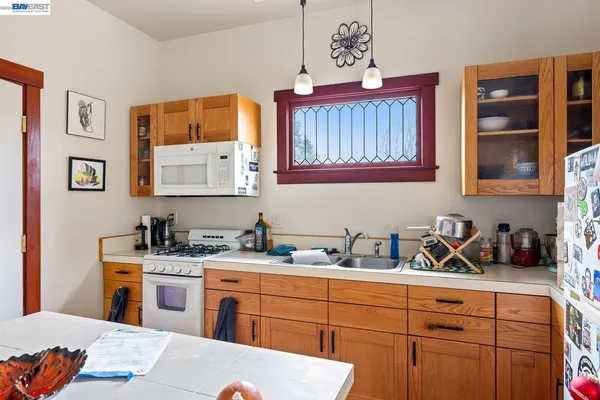 a kitchen with stainless steel appliances a sink dishwasher stove and cabinets