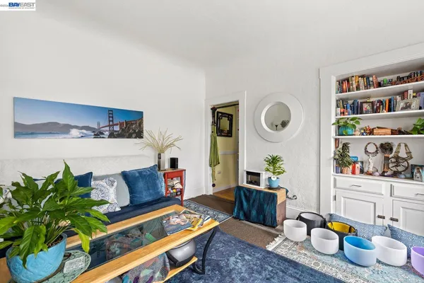 a living room with furniture and book shelf