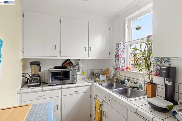 a kitchen with appliances a sink and cabinets