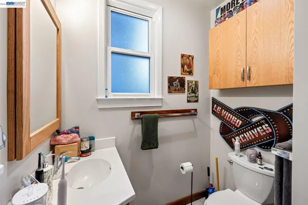 a bathroom with a sink toilet and mirror