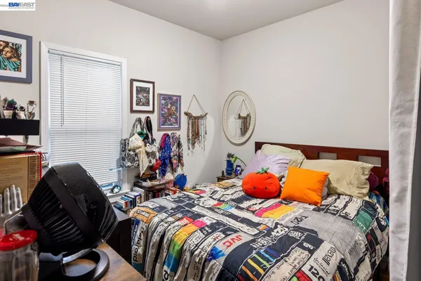 a bedroom with two bed and a lamp on dresser