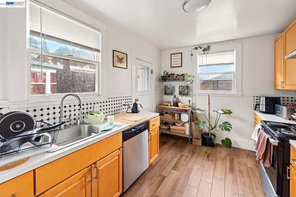 a kitchen with sink refrigerator and stove