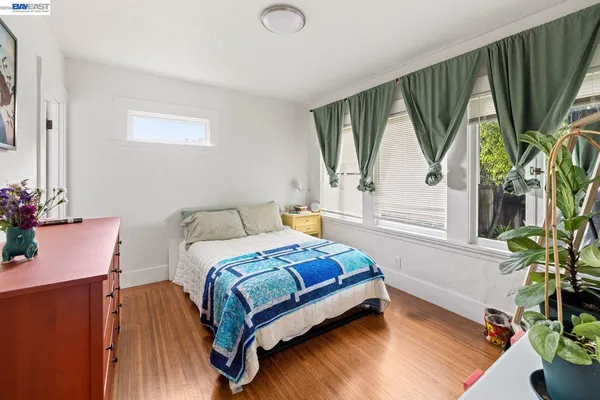 a bedroom with a bed window and a potted plant