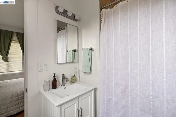 a bathroom with a sink vanity and a mirror