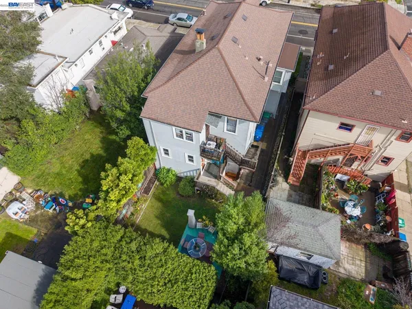 an aerial view of a house with a yard and garden