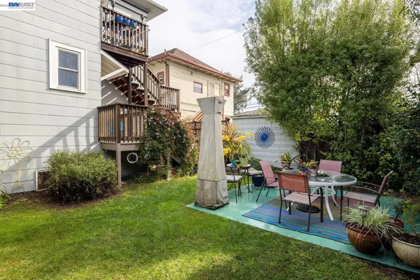 a view of a chair and table in backyard of the house