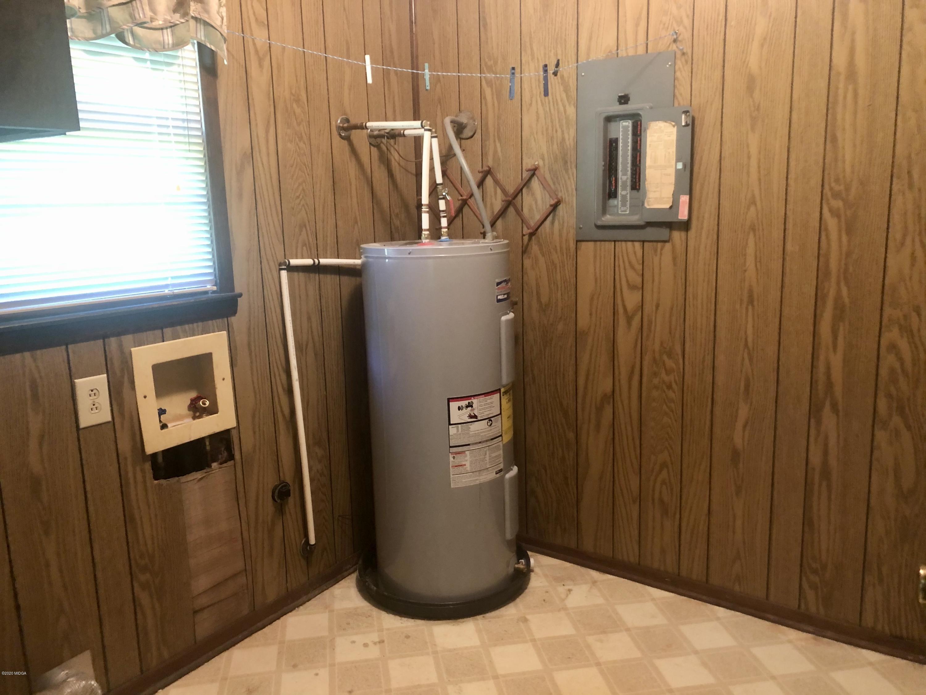 6656 Goodall Mill Road Macon, GA 31216 - Photo 8 of 21 a view of water heater room with a refrigerator