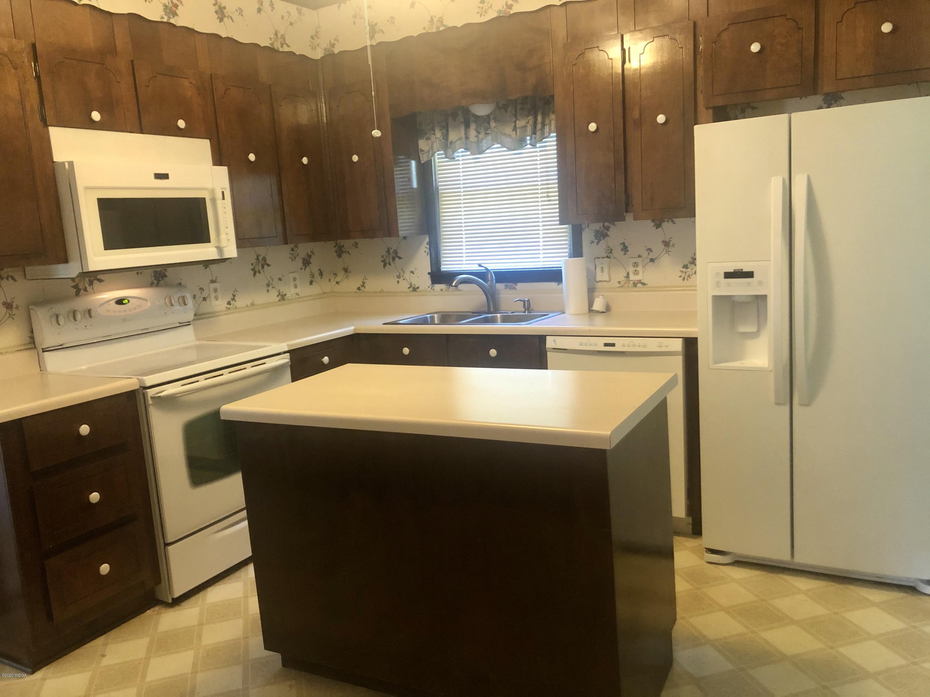 6656 Goodall Mill Road Macon, GA 31216 - Photo 9 of 21 a kitchen with a sink and a refrigerator