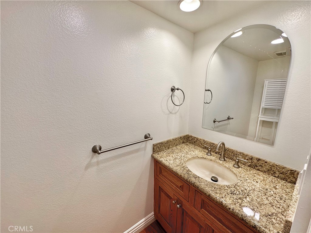 28005-28005 Ridgebluff Court Rancho Palos Verdes, CA 90275 - Photo 18 of 30 a bathroom with a granite countertop sink a mirror and shower
