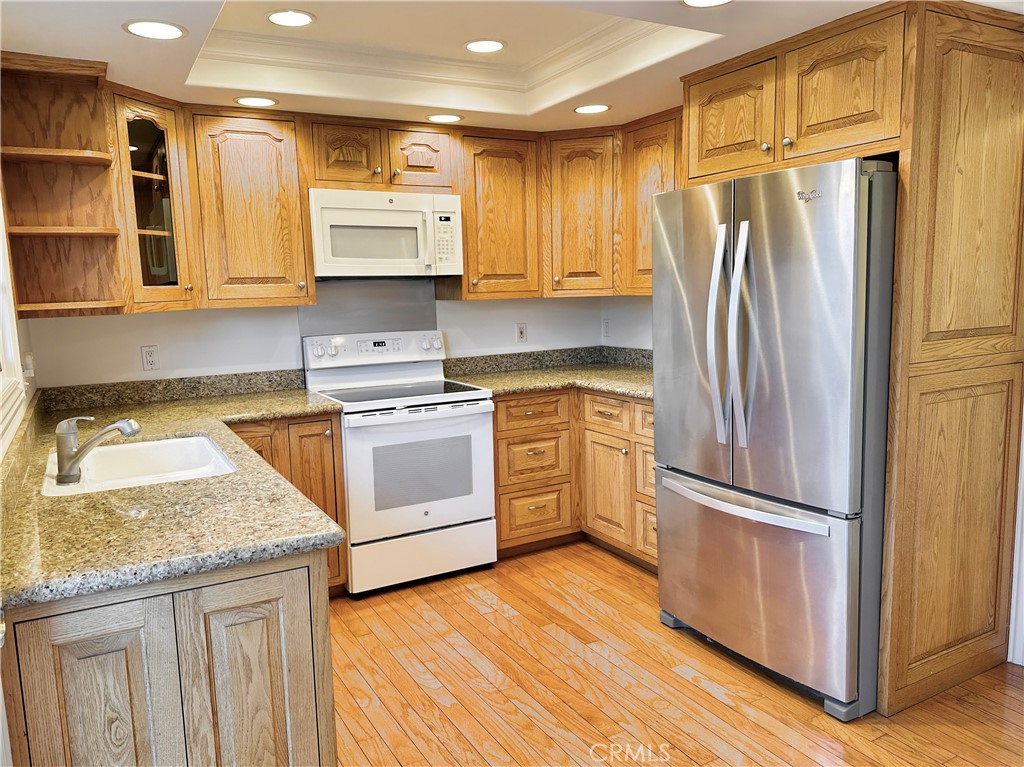 28005-28005 Ridgebluff Court Rancho Palos Verdes, CA 90275 - Photo 2 of 30 a kitchen with a refrigerator sink and cabinets