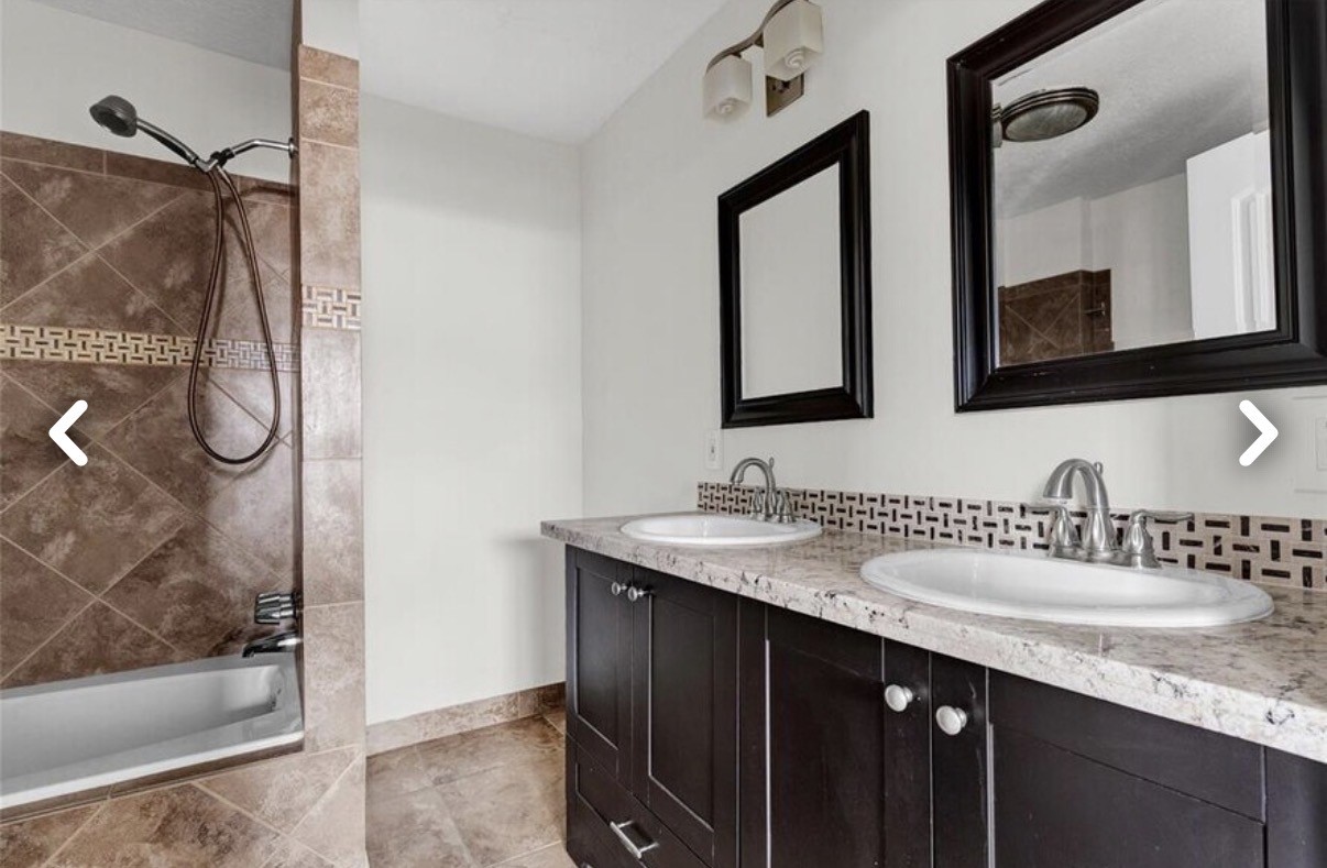 6009 Maple Street Houston, TX 77074 - Photo 4 of 11 a bathroom with a granite countertop sink a mirror and shower