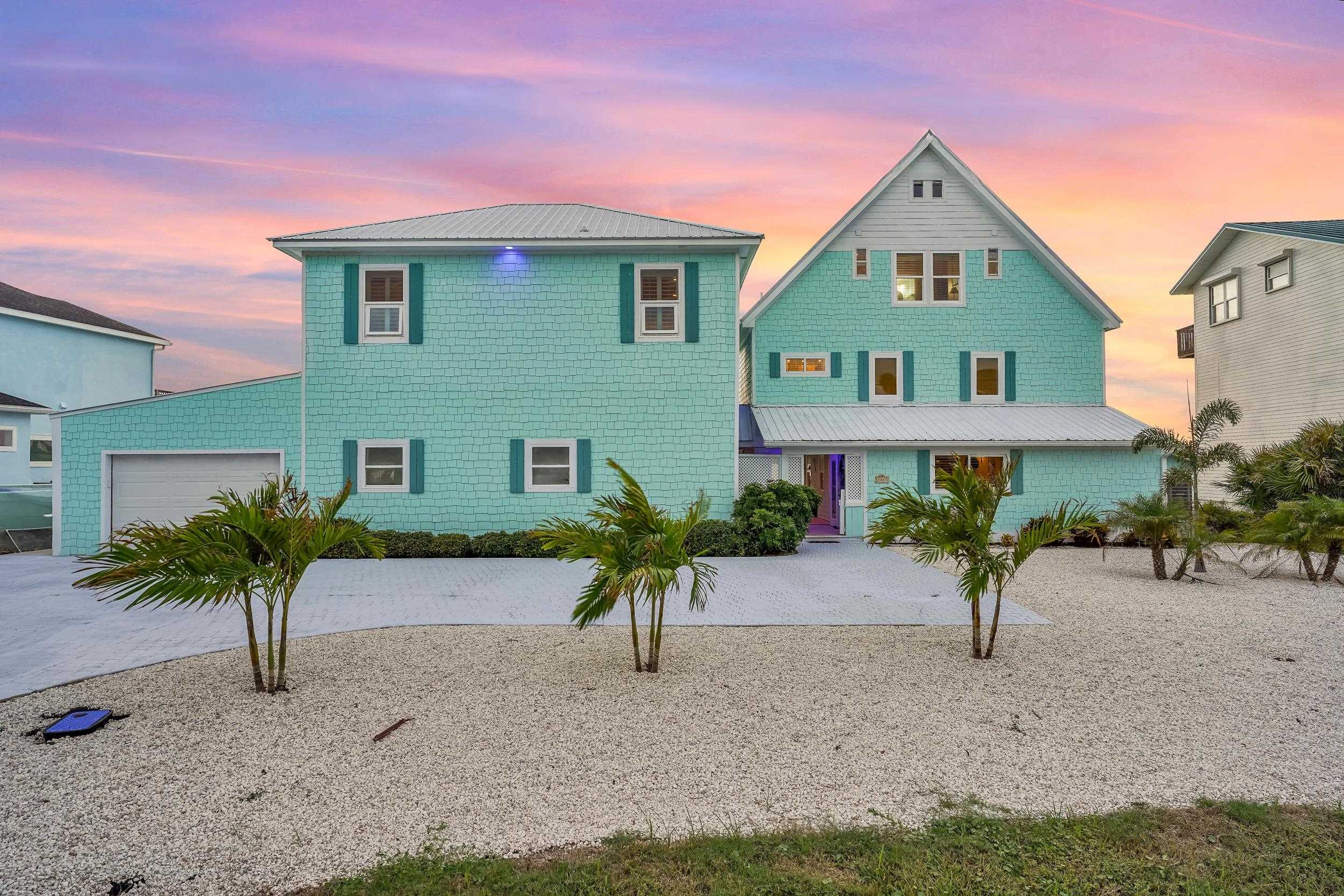 7337 A1A South St. Augustine, FL 32080 - Photo 12 of 100 View of front of home featuring an attached garage, driveway, and a metal roof