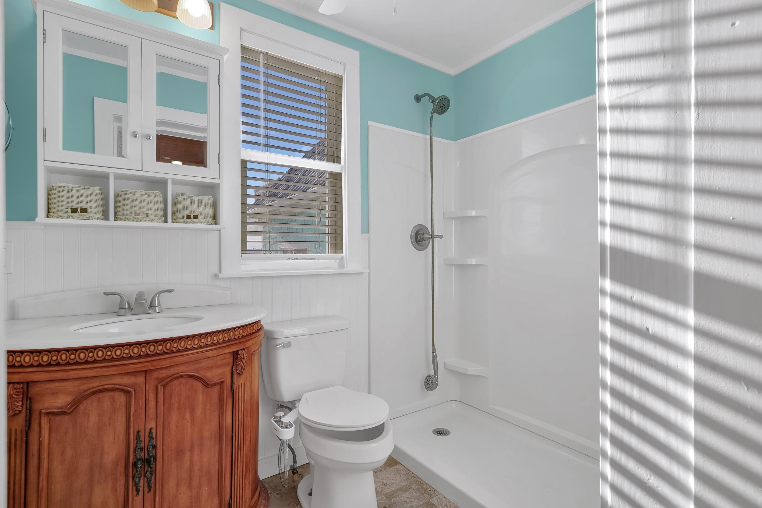 7337 A1A South St. Augustine, FL 32080 - Photo 31 of 100 Bathroom with vanity, a shower stall, crown molding, and a wainscoted wall