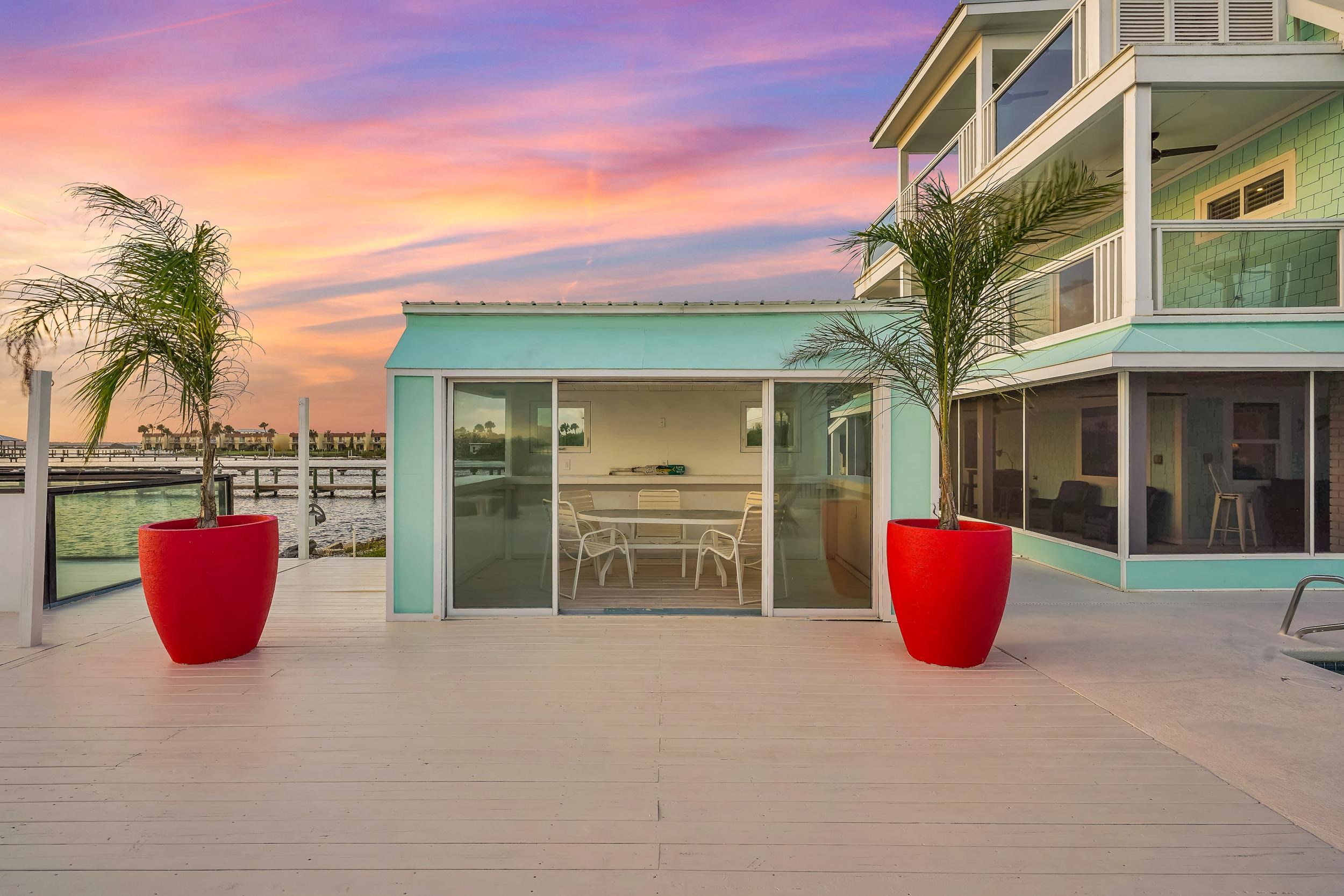 7337 A1A South St. Augustine, FL 32080 - Photo 41 of 100 Wooden terrace featuring a sunroom and outdoor dining space
