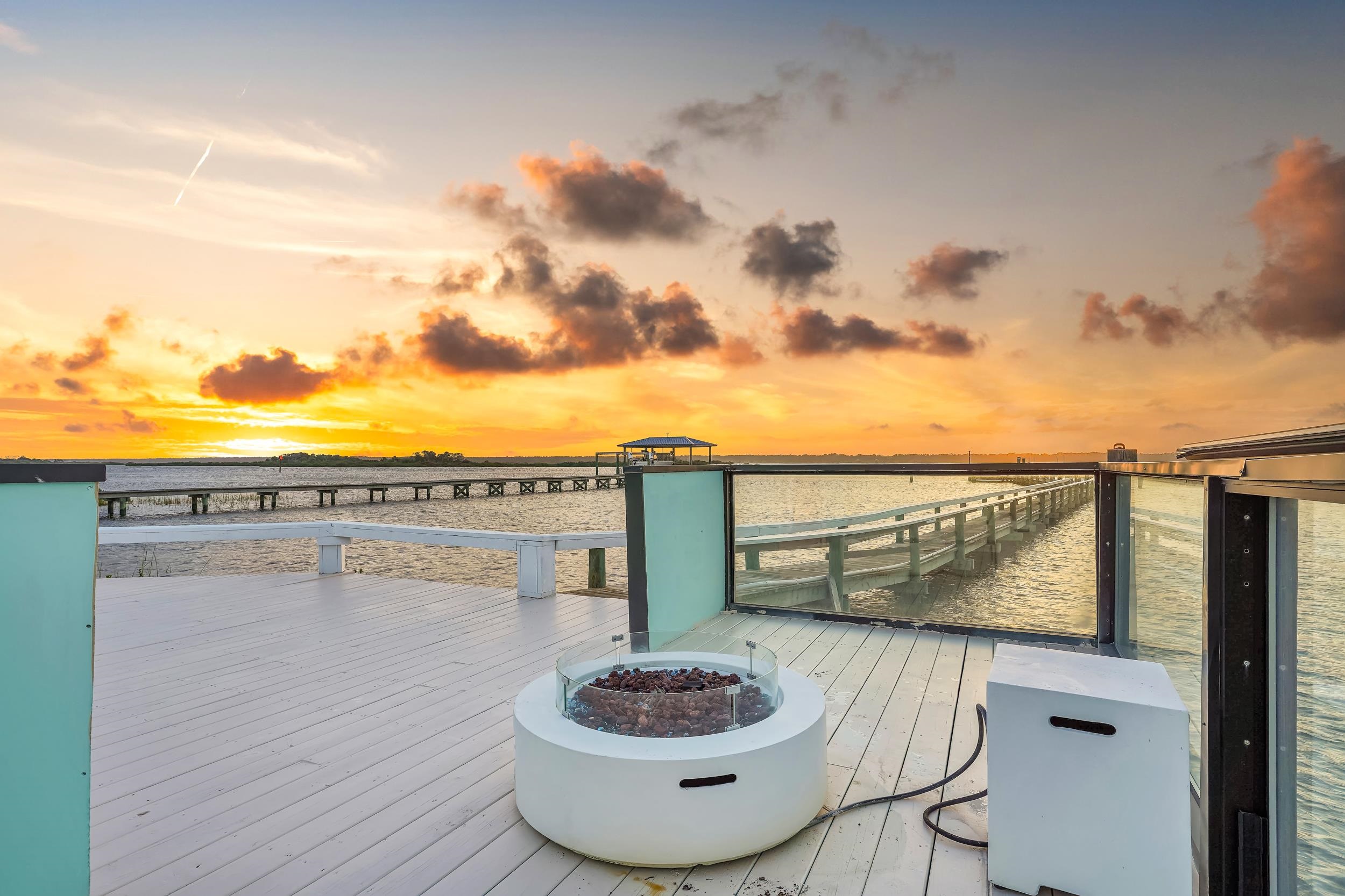7337 A1A South St. Augustine, FL 32080 - Photo 42 of 100 Deck at dusk featuring a fire pit and a water view