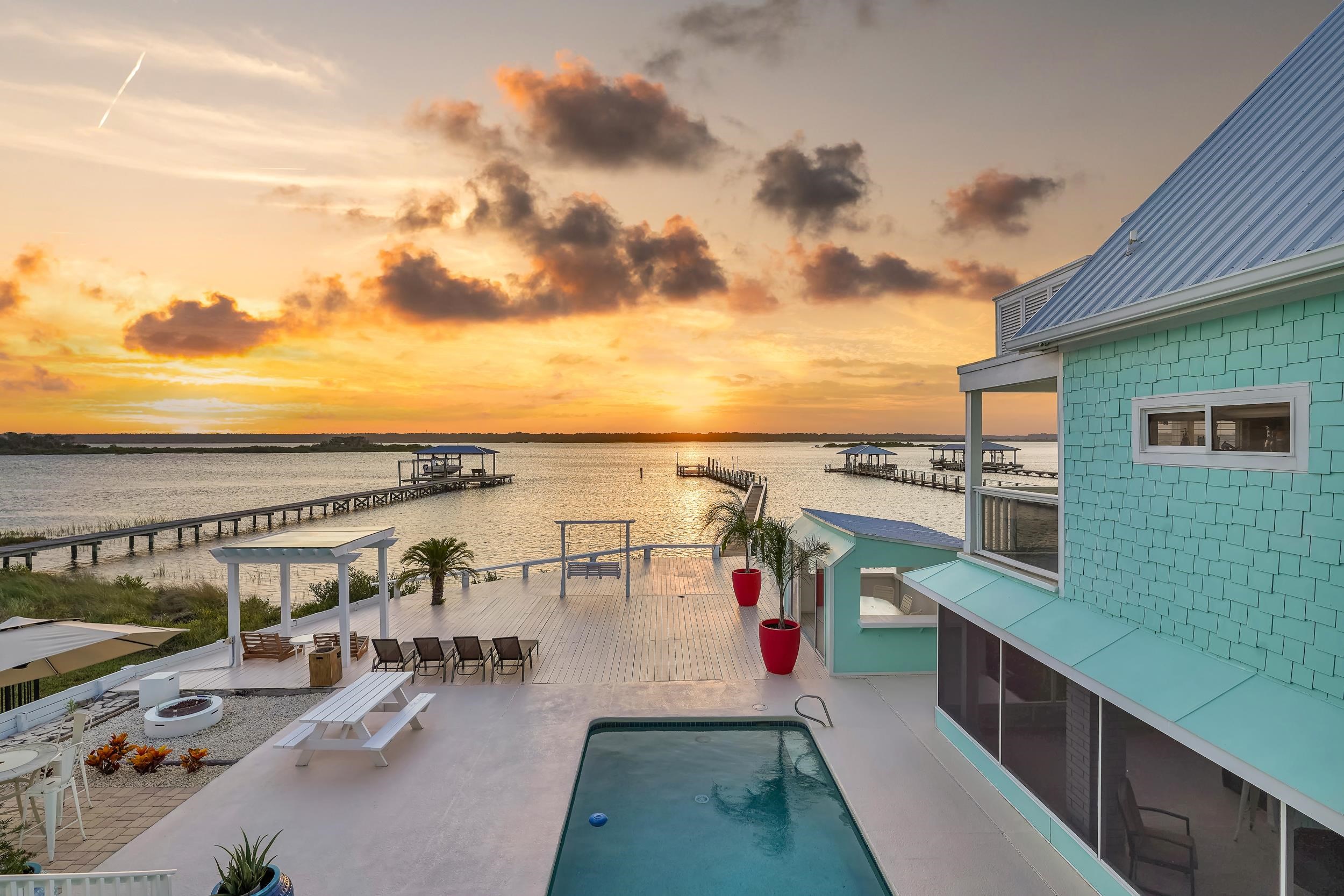 7337 A1A South St. Augustine, FL 32080 - Photo 46 of 100 Pool at dusk featuring a water view, an outdoor fire pit, a patio area, and a pergola