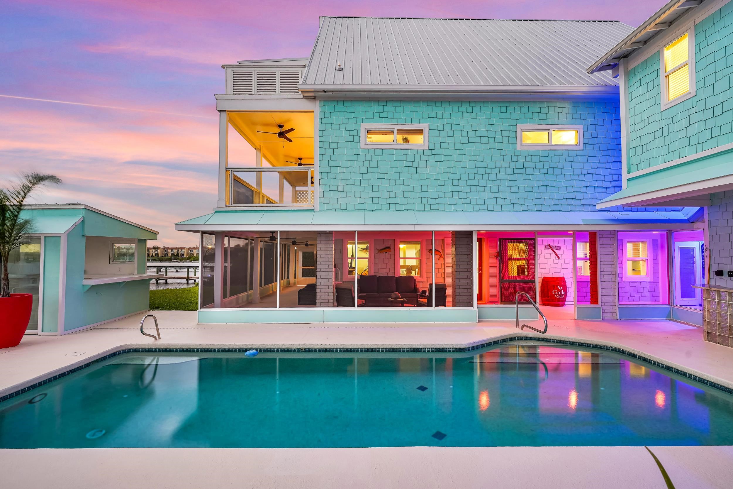 7337 A1A South St. Augustine, FL 32080 - Photo 48 of 100 Pool at dusk featuring an outdoor pool, a balcony, ceiling fan, and a sunroom
