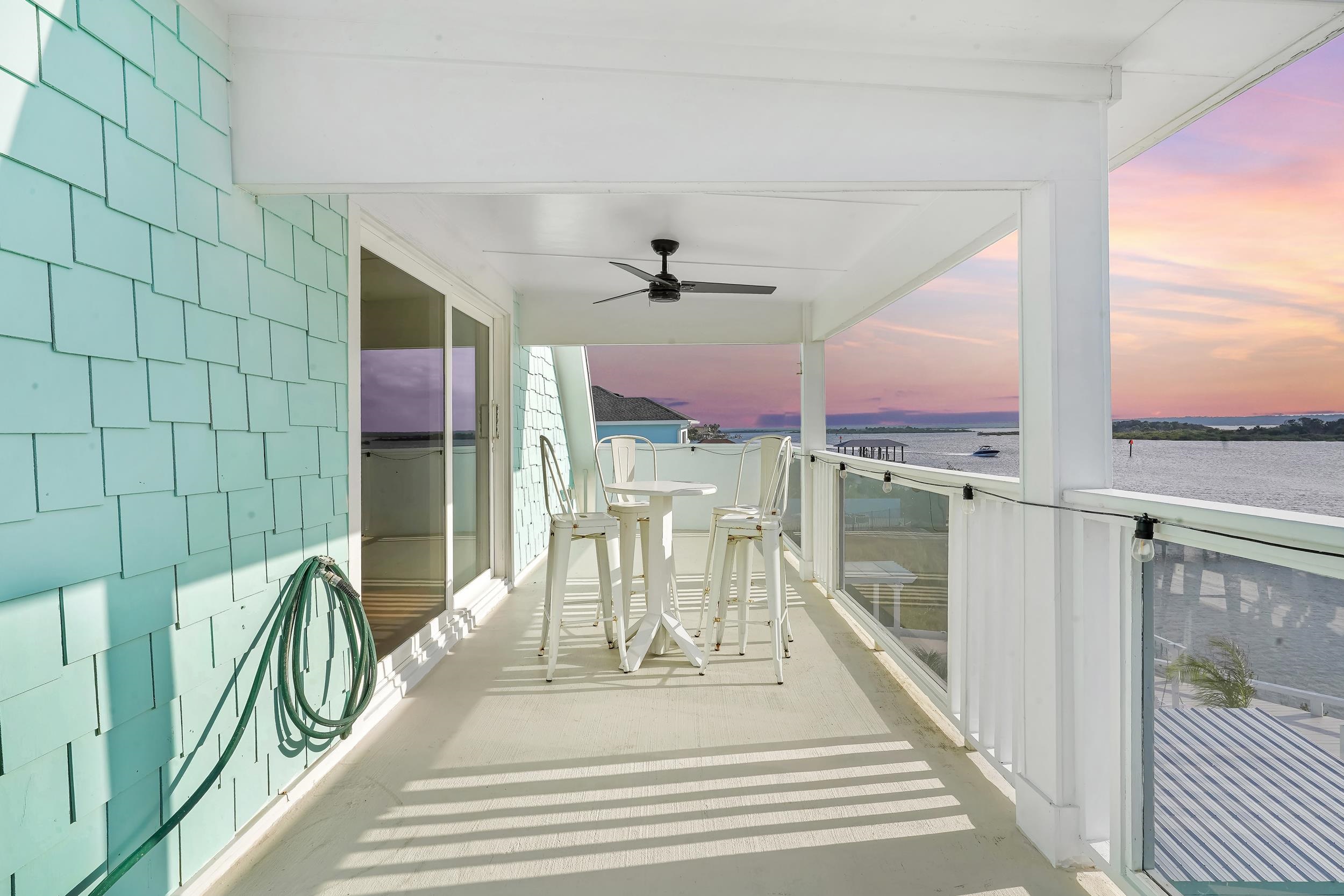 7337 A1A South St. Augustine, FL 32080 - Photo 59 of 100 Balcony at dusk featuring a ceiling fan and a sunroom
