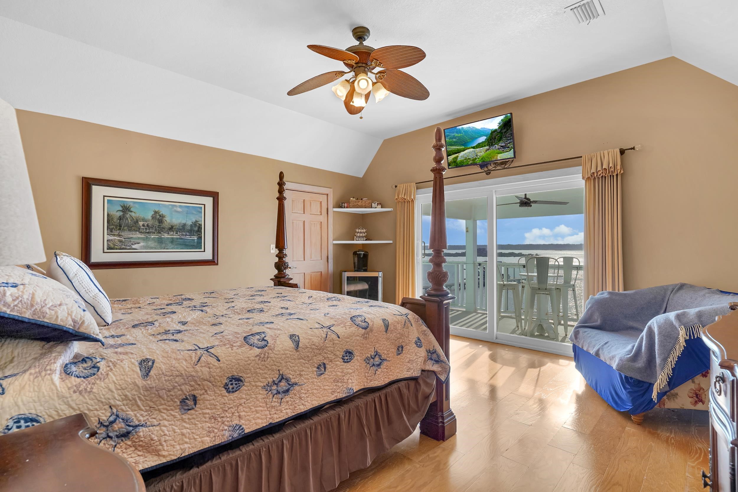 7337 A1A South St. Augustine, FL 32080 - Photo 61 of 100 Bedroom featuring lofted ceiling, light wood-type flooring, access to exterior, and a ceiling fan