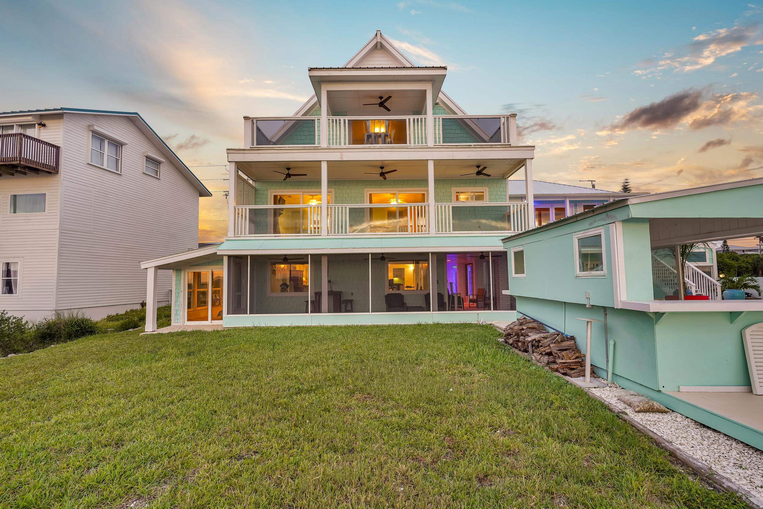 7337 A1A South St. Augustine, FL 32080 - Photo 62 of 100 Back of property at dusk featuring a lawn, a balcony, and a ceiling fan