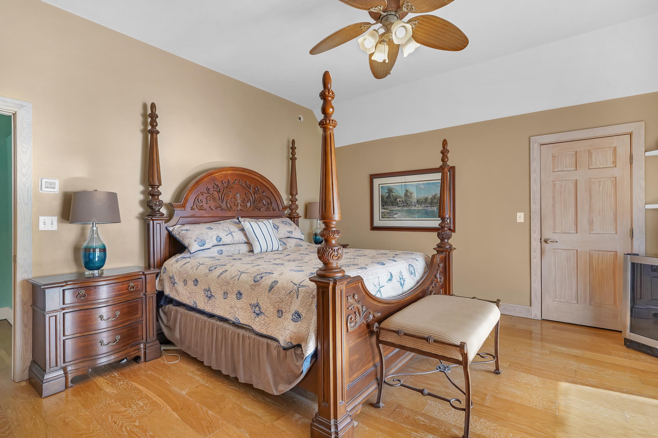7337 A1A South St. Augustine, FL 32080 - Photo 62 of 100 Bedroom with light wood-type flooring, a ceiling fan, and wine cooler
