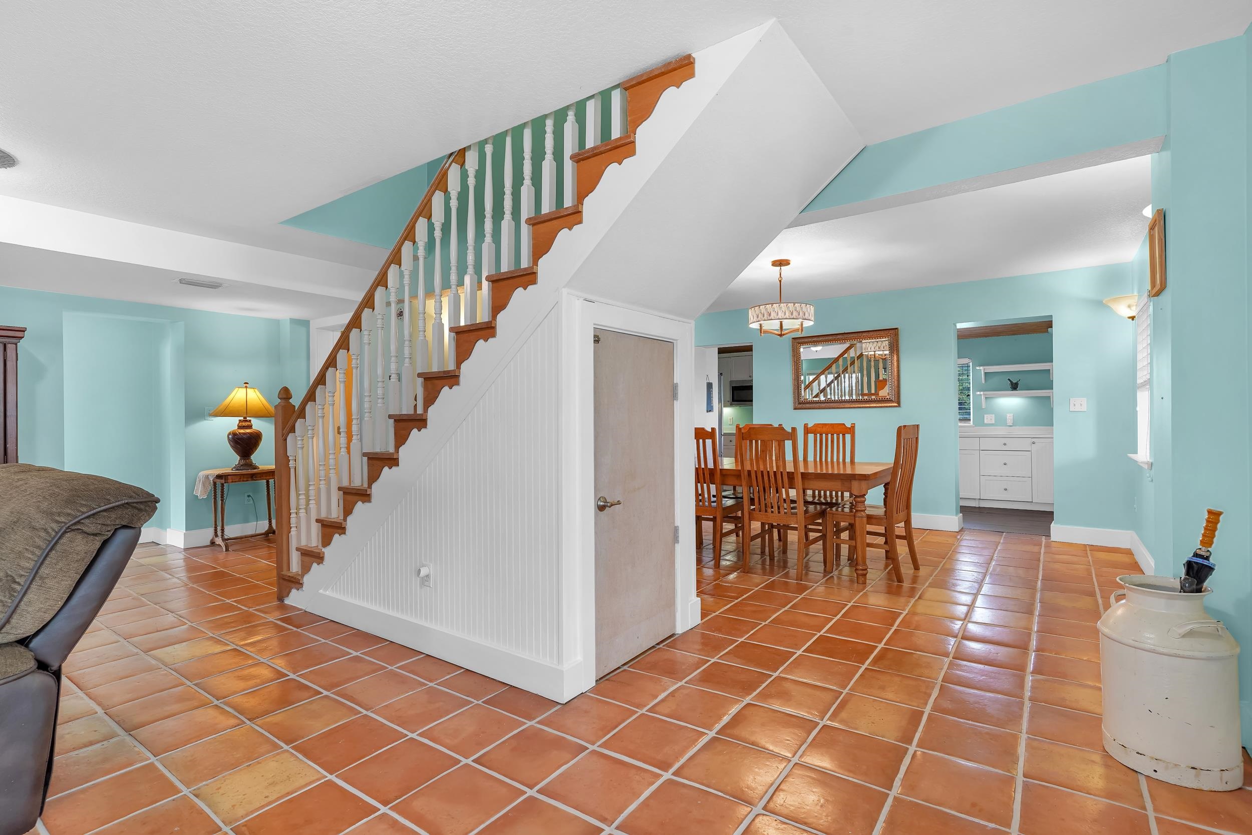 7337 A1A South St. Augustine, FL 32080 - Photo 67 of 100 Stairway with tile patterned floors and a chandelier