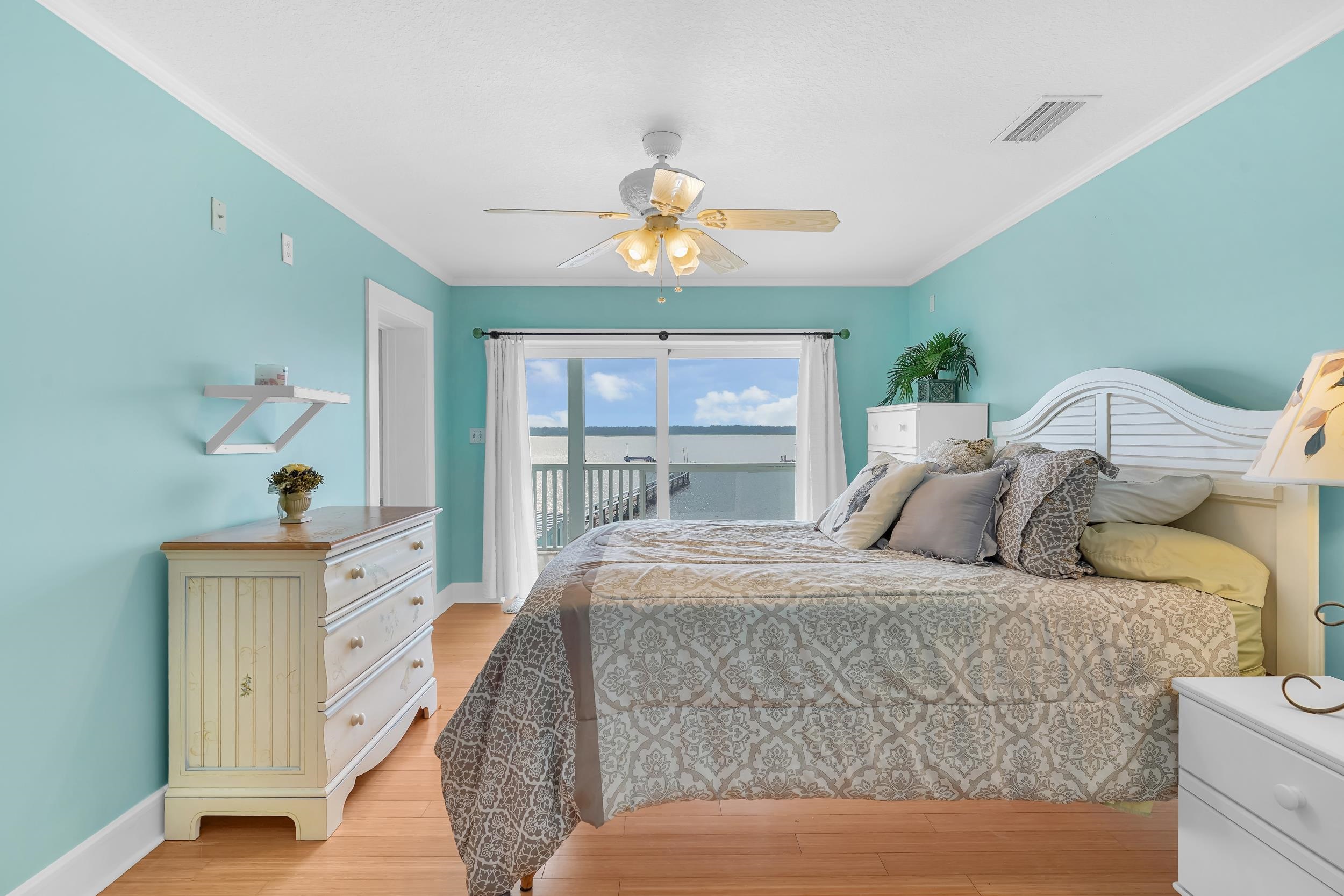 7337 A1A South St. Augustine, FL 32080 - Photo 73 of 100 Bedroom featuring access to outside, light wood-type flooring, crown molding, and a ceiling fan
