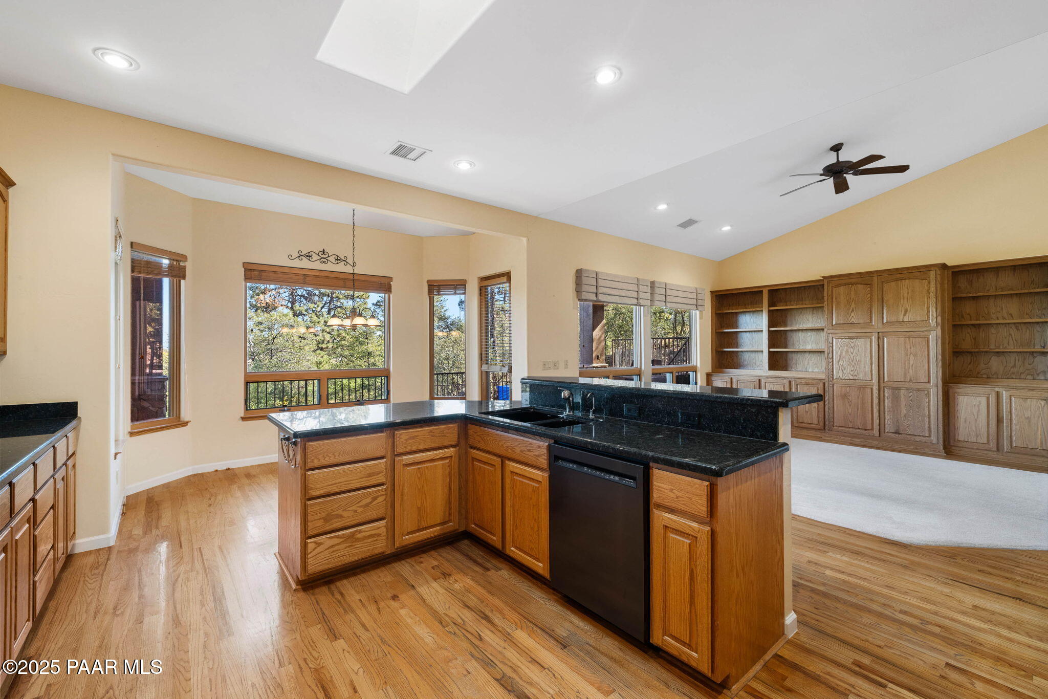 1741 Conifer Ridge Lane Prescott, AZ 86303 - Photo 18 of 78 a kitchen with stainless steel appliances granite countertop a sink and wooden floor