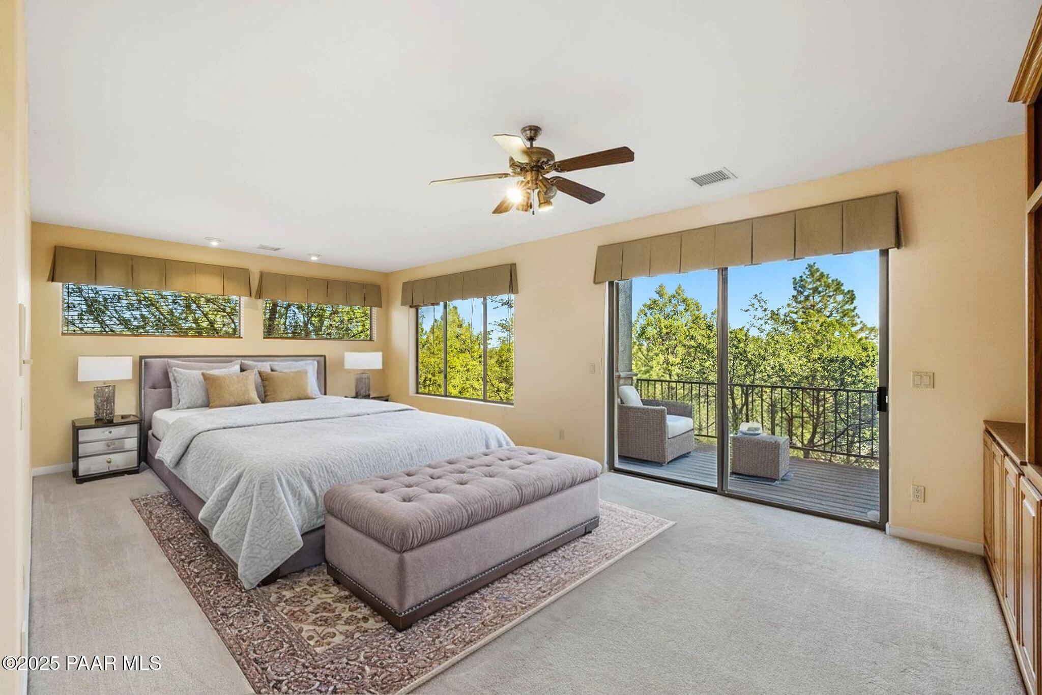 1741 Conifer Ridge Lane Prescott, AZ 86303 - Photo 31 of 78 a bedroom with a large bed and a balcony