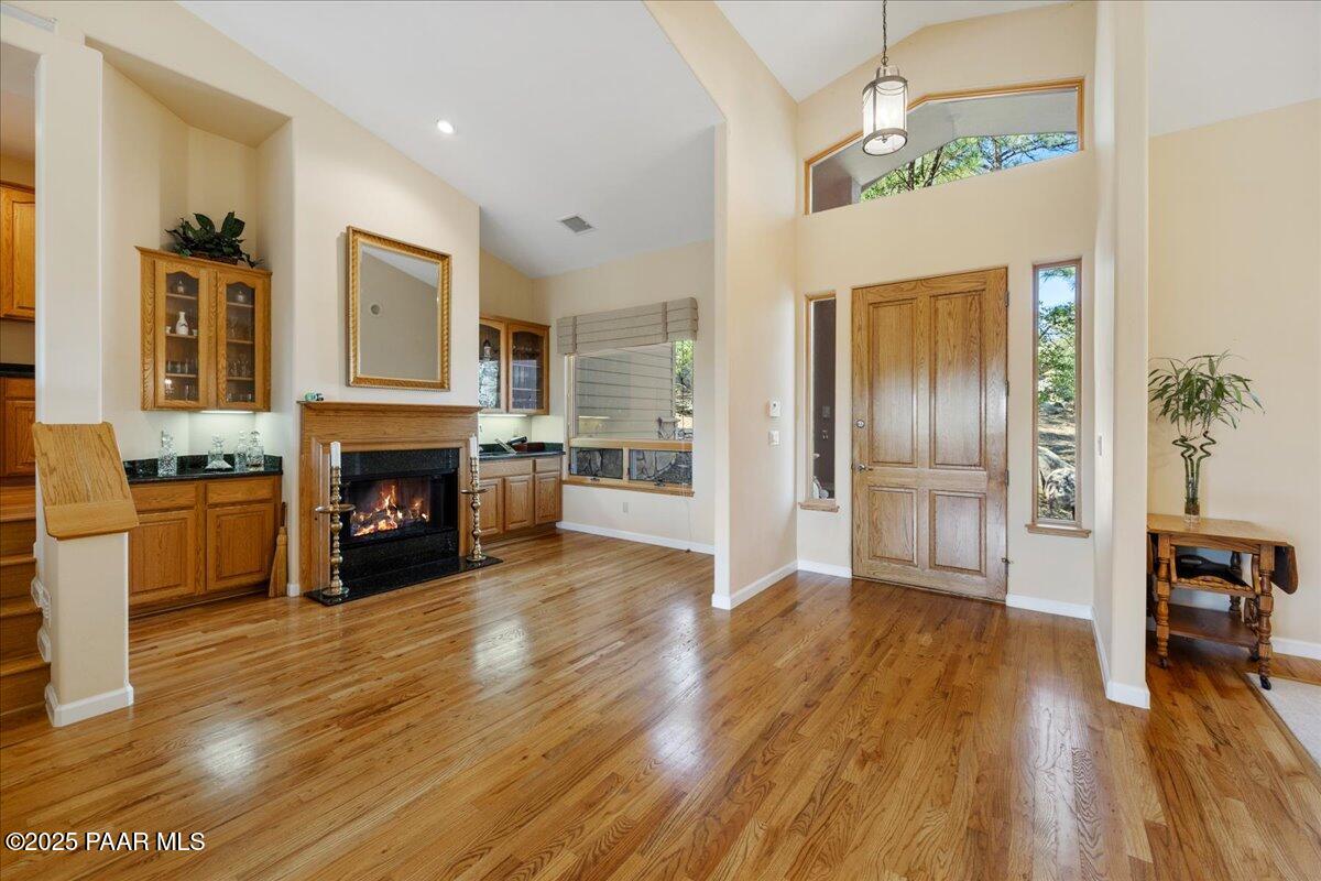 1741 Conifer Ridge Lane Prescott, AZ 86303 - Photo 9 of 78 a view of an empty room with fire place and a kitchen view