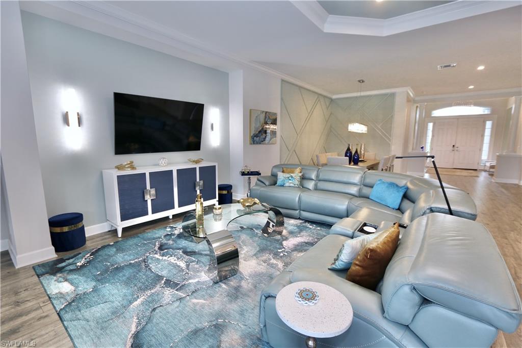 8337 Promoso Court Naples, FL 34114 - Photo 19 of 48 a living room with furniture and a flat screen tv