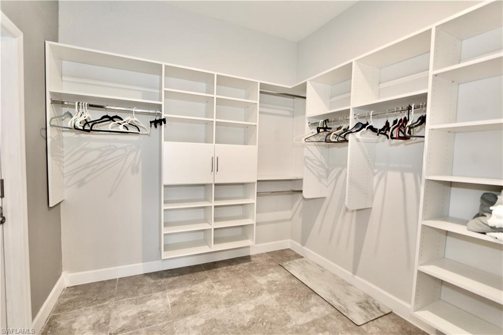 8337 Promoso Court Naples, FL 34114 - Photo 28 of 48 a view of walk in closet with empty racks
