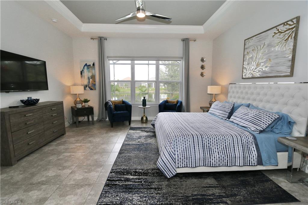 8337 Promoso Court Naples, FL 34114 - Photo 5 of 48 a bedroom with a bed and flat screen tv